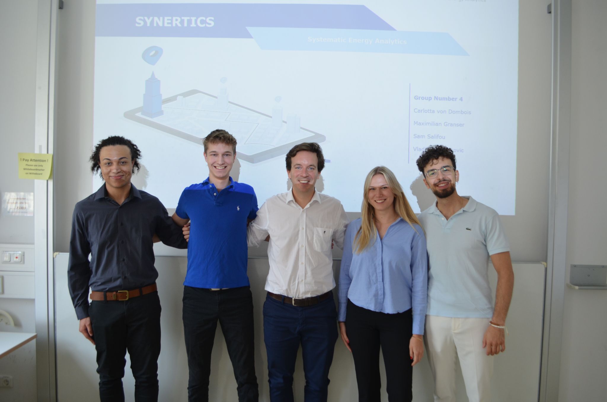 Students group in class with Synertics founder at LMU